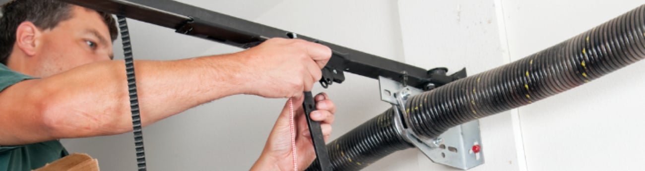 Technician Working on Damage Garage Door