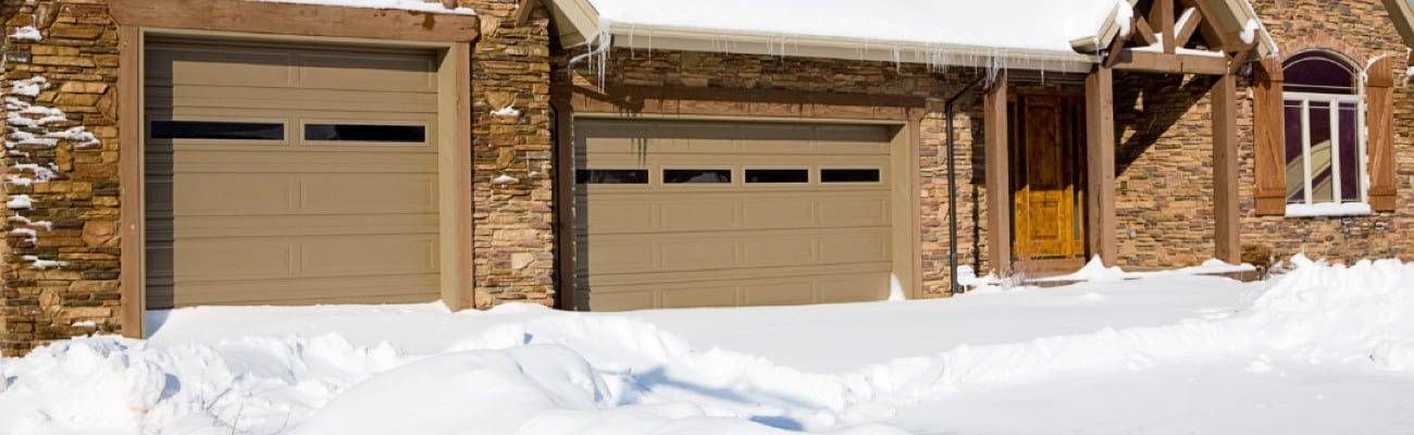 Double Garage Door House Covered in Snow Double Garage Door House Covered in Snow
